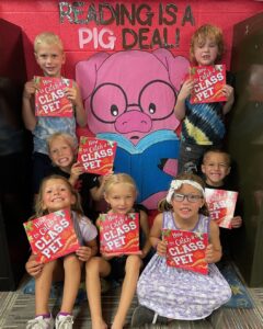 Gackle-Streeter smiling first grade students with their new books.