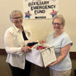 AEF Chairman Cheryl Evenson (left) presents giveaway basket to winner Lynn Helm at Department Convention.