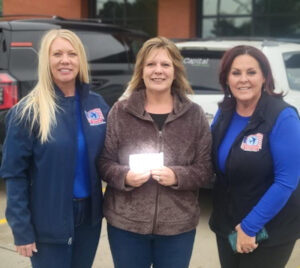 Western ND Honor Flight Donation Western North Dakota Board Members Crystal Strand and Patience Mosbrucker with Gackle Auxiliary member Marella Koenig (middle).