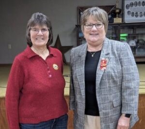 two people standing - Elaine Ackerman (left) with Mona Klose, 65-year Auxiliary member.