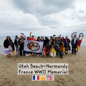 Large group photo of Young Hawk/Bear Unit and Post 253 members on beach of Normandy